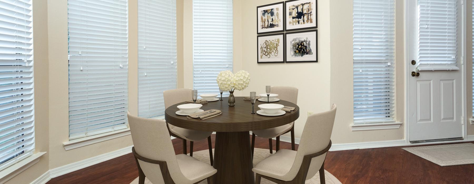 a dining room table with white chairs